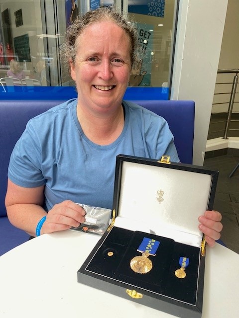 Photo of Kim smiling with her medals