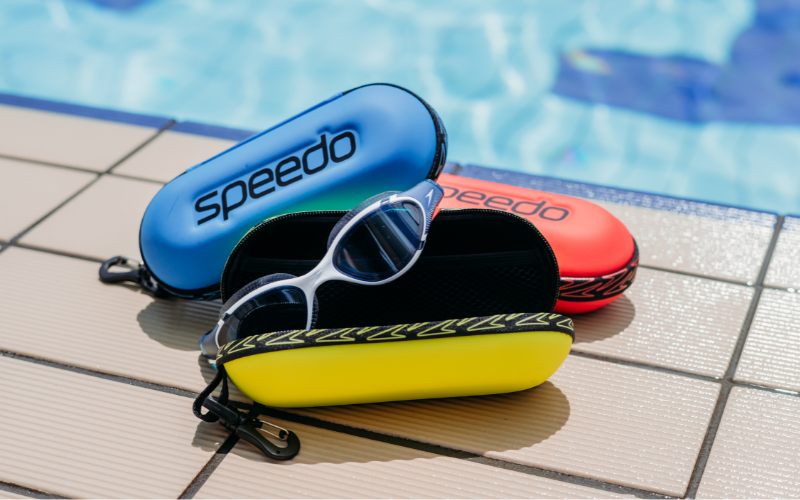 Speedo Goggles sitting in Protective Speedo Goggles Case Pictured in front of Pool