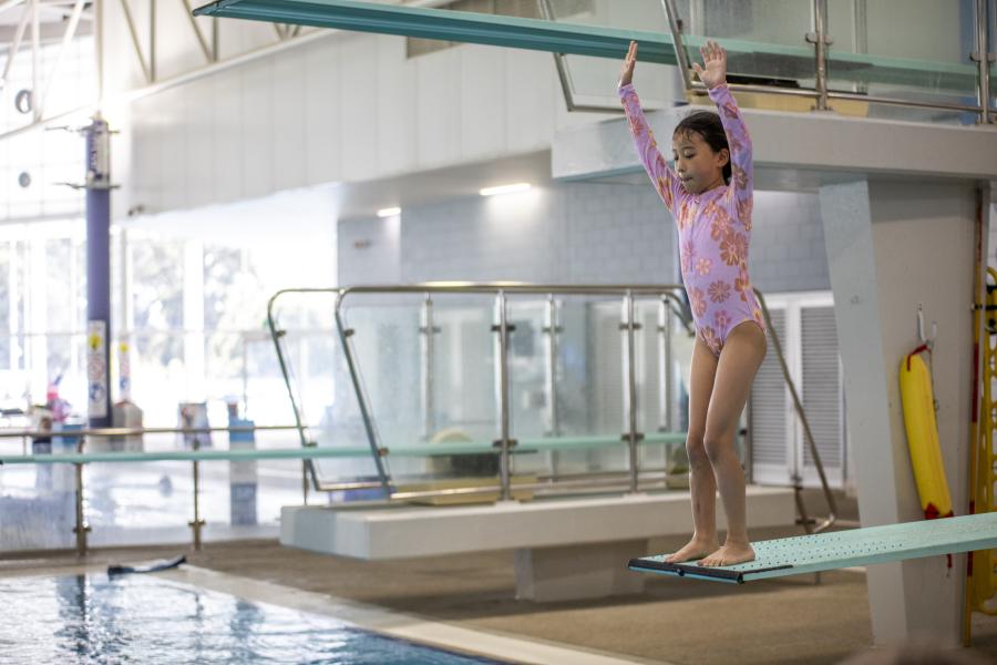 Young girl on small diving board at Aqualink Box Hill