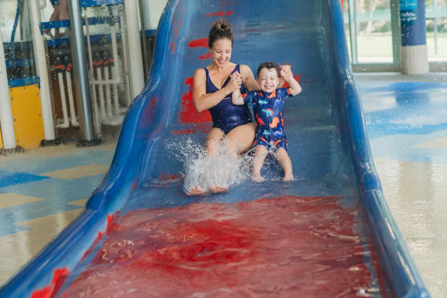 Mother and Son slide down slide at Aqualink Box Hill Splash Pad