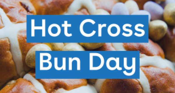 Image of Hot Cross Buns with easter eggs scatter among them. text over the top 'Hot Cross Bun Day'