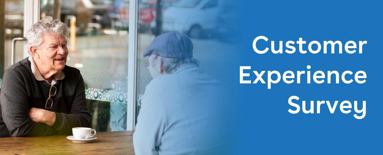 Image of two older gentlement having a coffee out the front of Aqualink Box Hill, positioned to the left, right aligned text over a blue backgroun 'Customer Experience Survey'