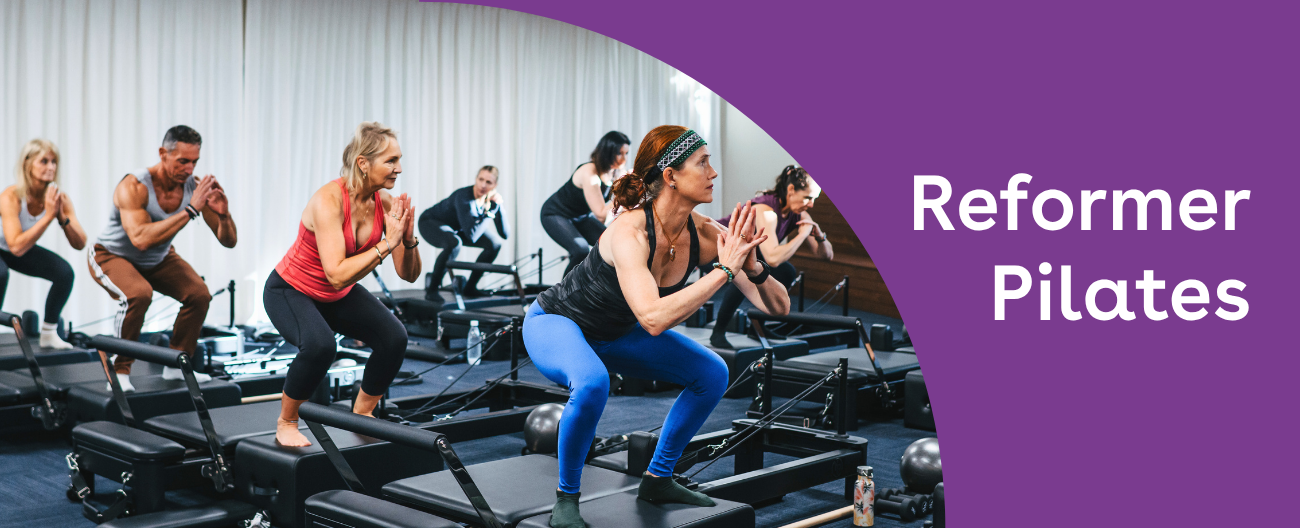 Image of people on pilates reformer machines, in a squat with their hands joined by the palms. Text 'Reformer Pilates' to the right.